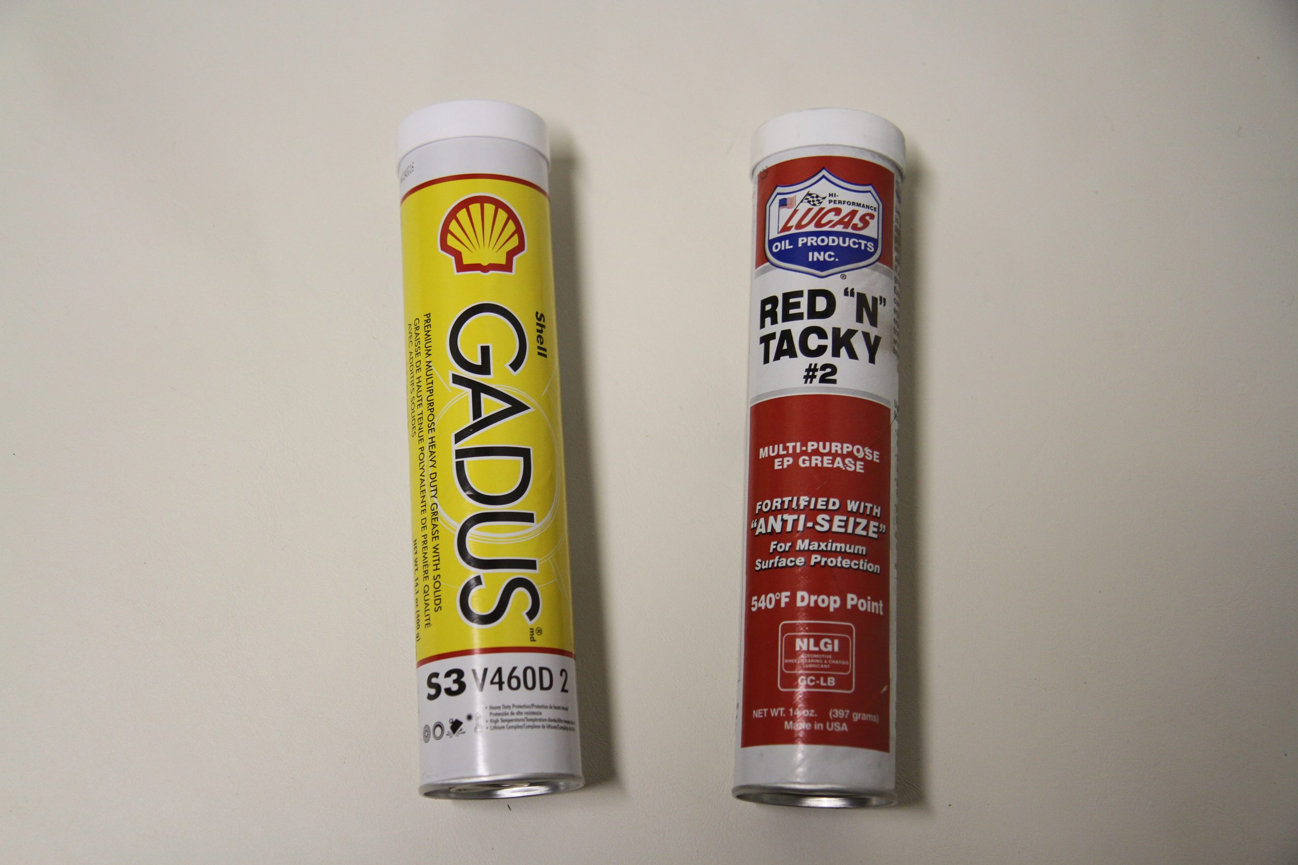 Side by side of Shell's Gadus moly grease and Lucas Oil's Red n' Tacky.